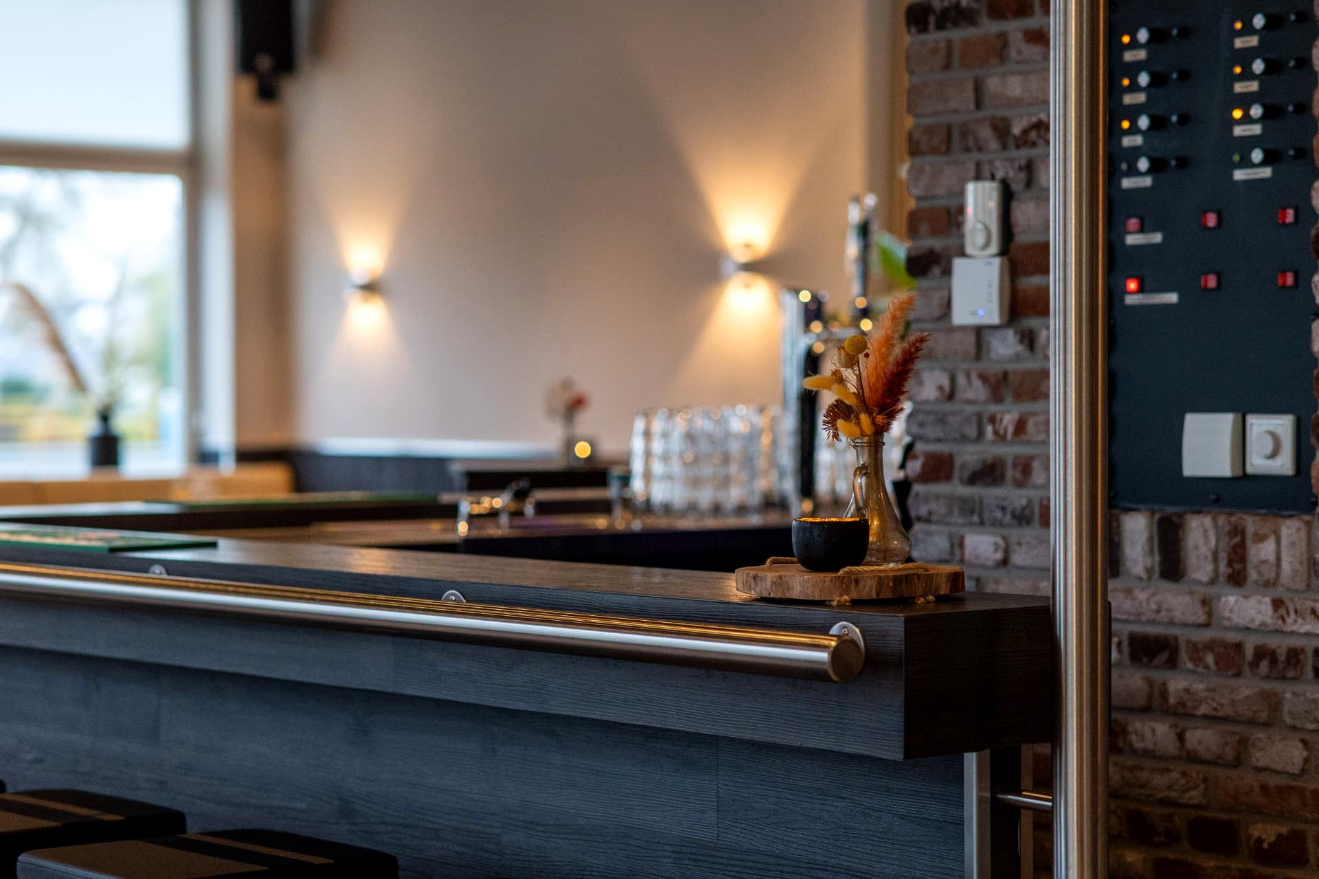 Bar langs de bakstenen wand met sfeerverlichting in D' Olde Skoele Rouveen