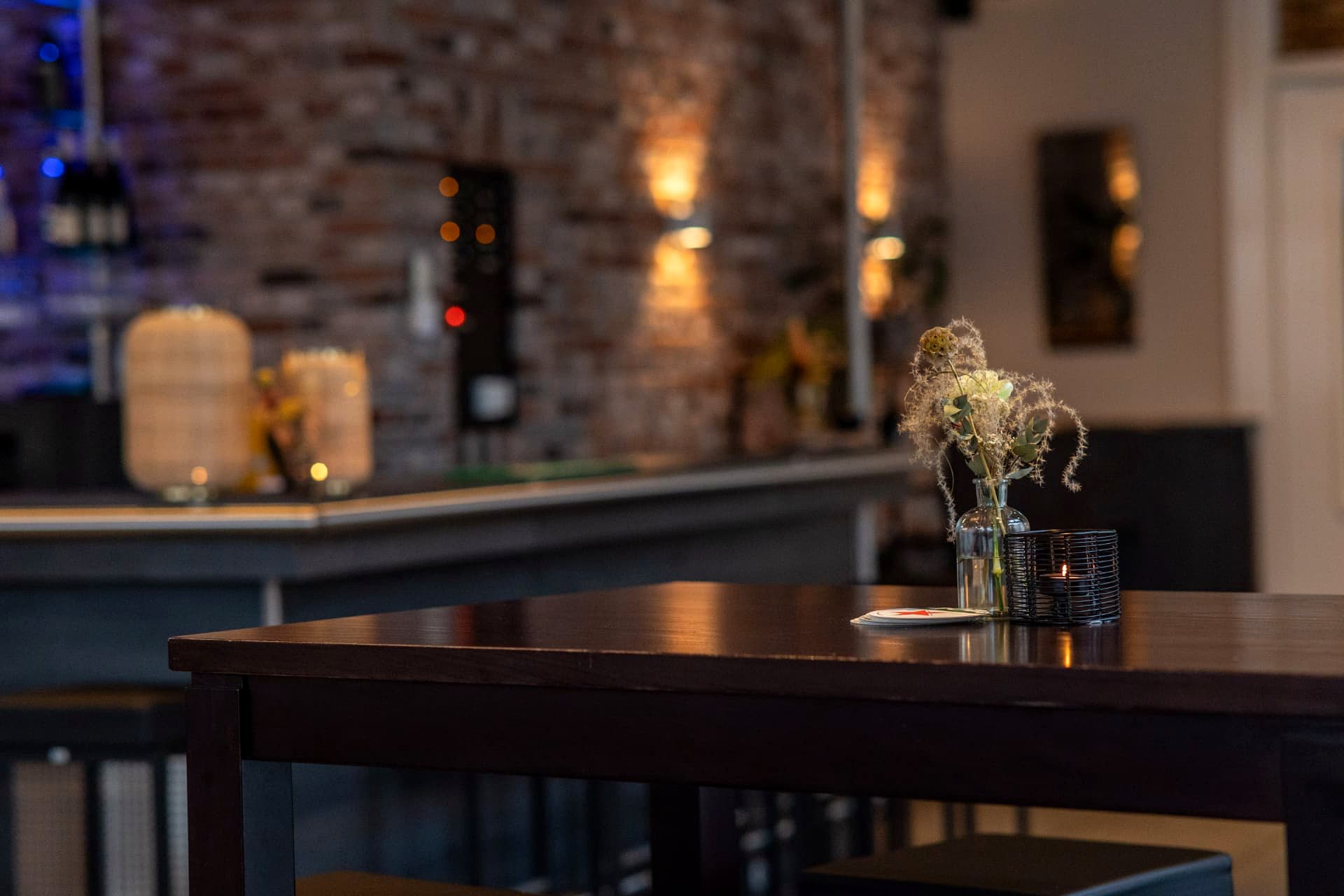 Statafel met droogbloemen en kaarslicht bij de bar van D' Olde Skoele in Rouveen